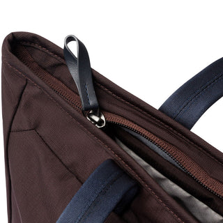 Bellroy Tokyo Tote Compact close-up of brown fabric and leather zipper pull with navy blue handles