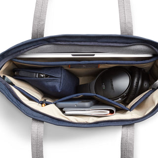 Bellroy Tokyo Tote Compact in navy with organized interior holding headphones and tech accessories