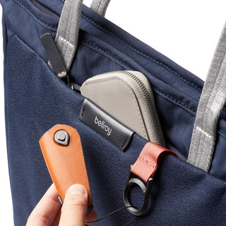 Bellroy Tokyo Tote Compact in navy with grey handles showing front pocket and accessories inside