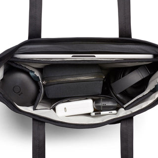 Bellroy Tokyo Tote Compact with organized interior holding laptop, headphones, and tech accessories in black fabric