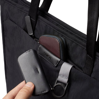 Bellroy Tokyo Tote Compact in black recycled fabric with front pocket holding accessories and keys