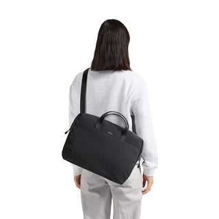 Bellroy Via Work Bag (Tech Briefcase) worn crossbody in black with slim nylon fabric and leather handles