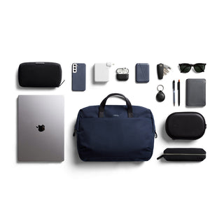 Bellroy Via Work Bag (Tech Briefcase) navy with tech essentials and accessories neatly arranged on white background