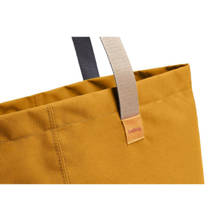 Bellroy Market Tote in mustard yellow fabric with contrasting beige and black handles close-up view