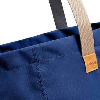 Bellroy Market Tote with navy recycled nylon fabric and contrasting beige and black handles close-up detail