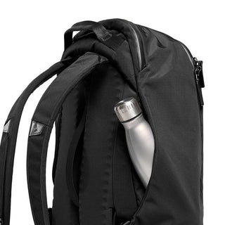 Bellroy Transit Backpack Plus showing black fabric, padded straps, and side pocket with silver water bottle