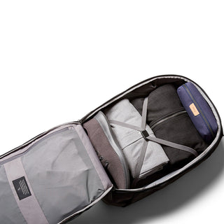Bellroy Transit Backpack Plus open, showing organized packed clothes and accessories inside compartments