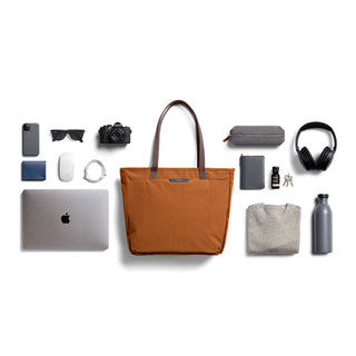Bellroy Tokyo Tote Second Edition in rust fabric with leather handles and everyday essentials around it
