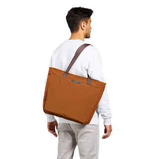 Bellroy Tokyo Tote Second Edition in rust color carried on shoulder with durable woven fabric