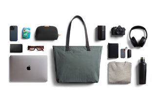 Bellroy Tokyo Tote Second Edition in green woven fabric with everyday tech and travel accessories laid out