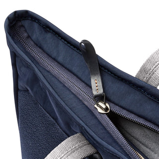 Bellroy Tokyo Tote Second Edition showing navy fabric with leather zipper pull and light gray handles close-up