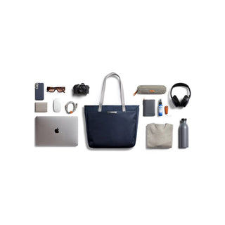 Bellroy Tokyo Tote Second Edition navy tote bag with leather handles shown with everyday tech and accessories