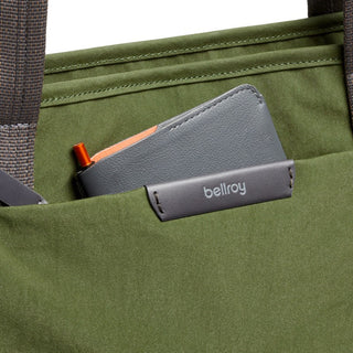 Bellroy Tokyo Tote Second Edition in olive with front pocket holding a grey Bellroy wallet and pen