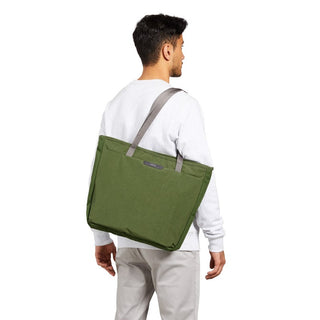 Man carrying olive green Bellroy Tokyo Tote Second Edition with gray straps over shoulder viewed from back