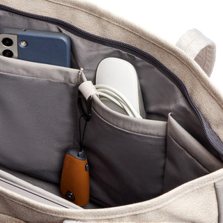 Bellroy Tokyo Tote Second Edition in beige showing organized interior pockets with tech accessories inside