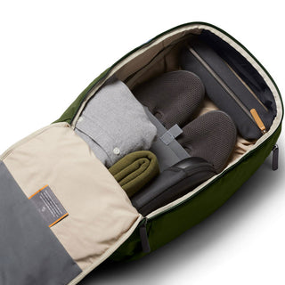 Bellroy Transit Workpack 20L open showing organized clothes, shoes, and olive green exterior fabric