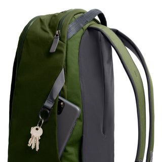 Bellroy Transit Workpack 20L backpack in green and black with side pocket holding keys and phone
