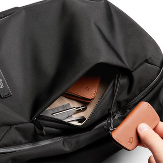 Black Bellroy Transit Workpack 20L (Second Edition) showing front pocket with leather accessory and pens inside