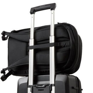 Bellroy Transit Workpack 20L (Second Edition) in black secured on silver luggage handle with padded straps visible