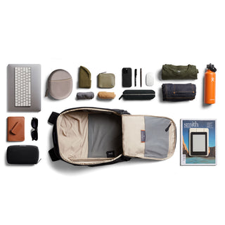 Bellroy Transit Workpack 20L (Second Edition) open with organized daily essentials around it in flat lay view