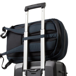 Bellroy Transit Workpack 20L (Second Edition) navy backpack secured on suitcase handle, showing padded straps and fabric texture