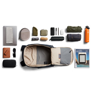 Bellroy Transit Workpack 20L (Second Edition) open with organized tech, accessories, and clothing laid out on white background