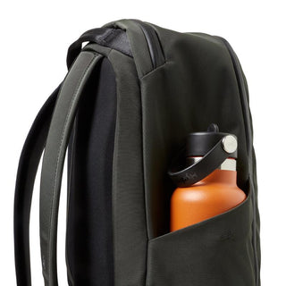 Bellroy Transit Workpack 20L (Second Edition) in dark green with side pocket holding an orange bottle
