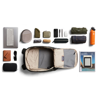 Bellroy Transit Workpack 20L (Second Edition) open with organized daily essentials laid out around it