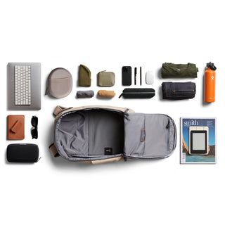Bellroy Transit Workpack 20L (Second Edition) in tan opened showing organized compartments and daily essentials laid out