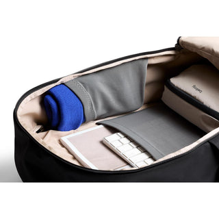 Bellroy Transit Workpack 26L showing organized interior with laptop sleeve and accessory pockets in neutral tones