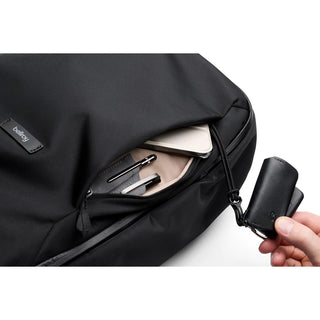Bellroy Transit Workpack 26L in black with front pocket holding pens and small notebook close-up