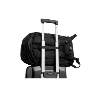 Bellroy Transit Workpack 26L backpack strapped to suitcase handle showing padded back and straps