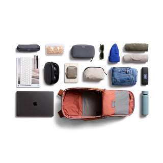 Bellroy Transit Workpack 26L open with neatly arranged tech, clothing, and accessories on white background
