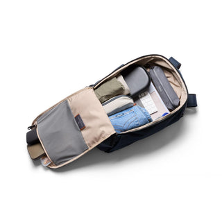 Bellroy Transit Workpack 26L open showing organized compartments with clothing and tech accessories inside