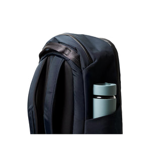 Bellroy Transit Workpack 26L showing navy blue fabric and side pocket holding a light blue bottle