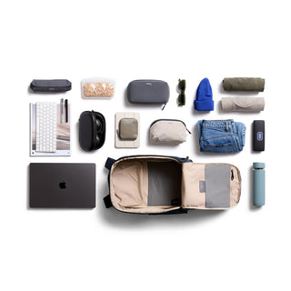 Bellroy Transit Workpack 26L open with neatly arranged travel essentials on white background