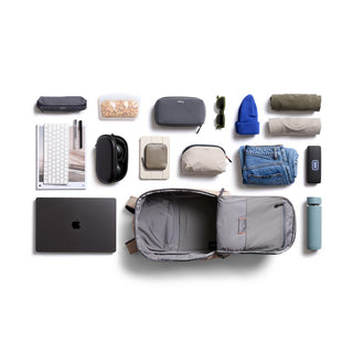 Bellroy Transit Workpack 26L laid flat open with organized travel and tech essentials surrounding it