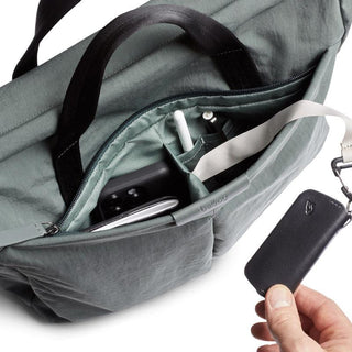 Bellroy Tokyo Messenger Bag 14" in green showing organized interior pockets and black strap detail