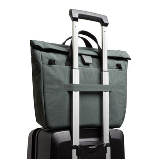 Bellroy Tokyo Messenger Bag 14" in green recycled fabric attached to suitcase handle viewed from back angle