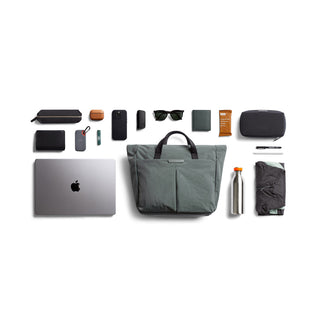 Bellroy Tokyo Messenger Bag 14" in muted green with multiple everyday carry items arranged around it