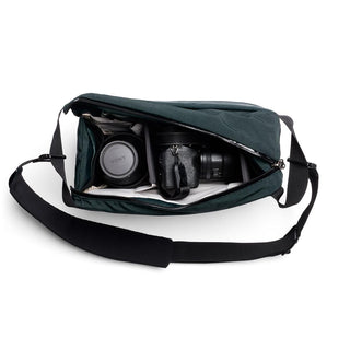Bellroy Venture Sling 10L - Camera Edition open flat showing camera gear with padded compartments in dark fabric