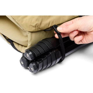 Bellroy Venture Sling 10L - Camera Edition securing black tripod with beige recycled fabric sling bag