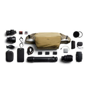 Bellroy Venture Sling 10L - Camera Edition in tan with camera gear and accessories laid out flat