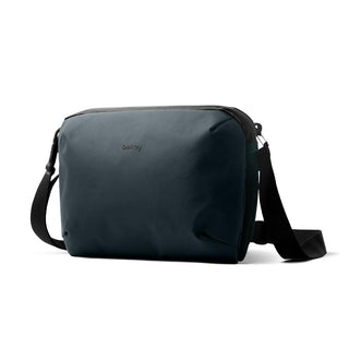 Bellroy Venture Travel Crossbody bag in dark recycled fabric with adjustable black strap shown from front angle