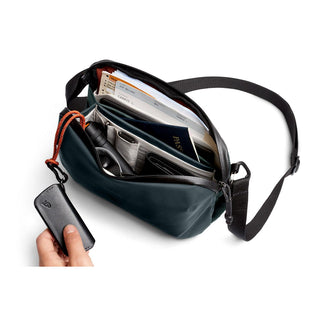 Bellroy Venture Travel Crossbody open, showing organized compartments with travel essentials inside