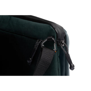 Close-up of black strap and zipper detail on dark green Bellroy Venture Travel Crossbody bag made from recycled materials