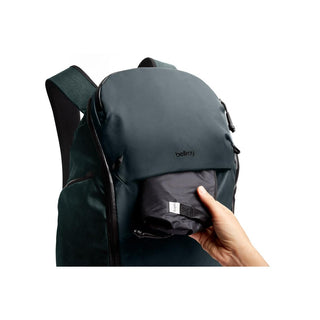 Bellroy Venture Travel Pack 26L in dark green recycled nylon with front pocket holding compact item