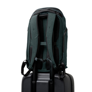 Bellroy Venture Travel Pack 26L dark green backpack shown from padded back and straps on suitcase handle