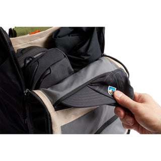 Bellroy Venture Ready Pack 20L showing hand storing a black cap in front zipper pocket with beige lining
