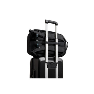 Bellroy Venture Ready Pack 20L black backpack attached securely on a suitcase handle with strap